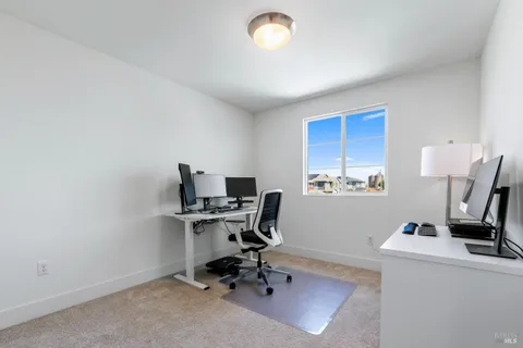 a view of workspace with wooden floor and white cabinet
