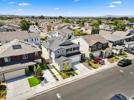 an aerial view of residential houses with outdoor space