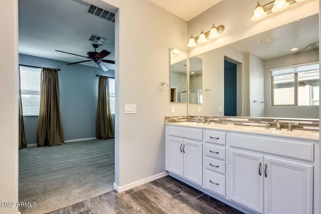 a bathroom with a granite countertop sink mirror and