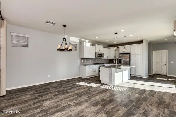 a kitchen with a refrigerator and microwave