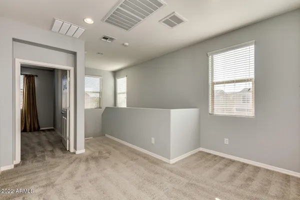 an empty room with windows and closet