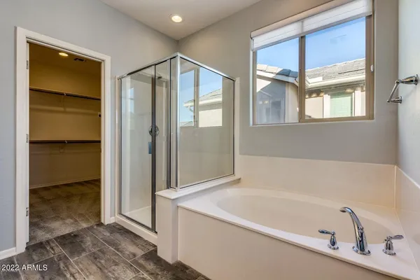 a bathroom with a tub and shower