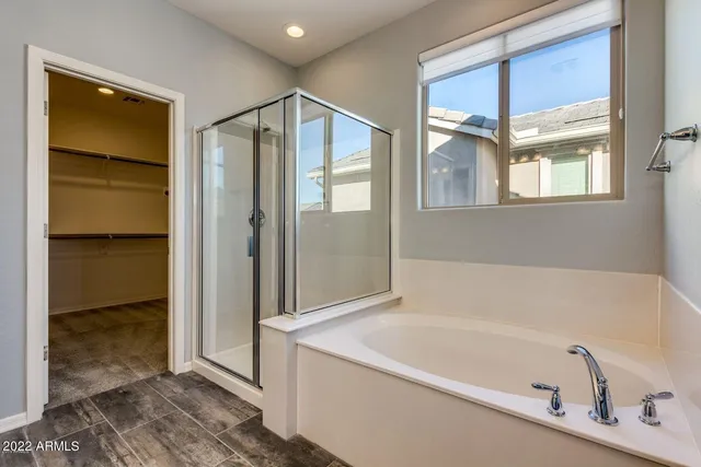 a bathroom with a tub and shower