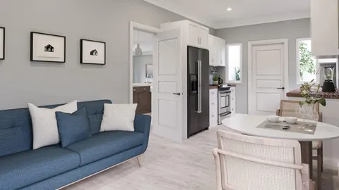 a living room with stainless steel appliances kitchen island furniture and a table