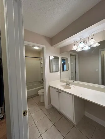 a spacious bathroom with a double vanity sink mirror and toilet