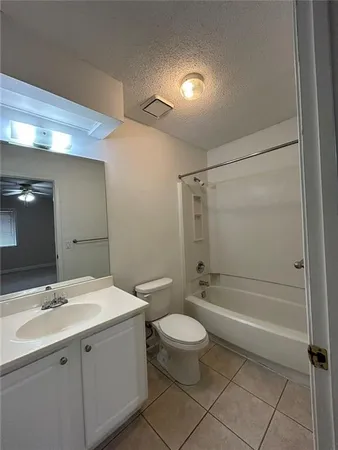a bathroom with a double vanity sink toilet and shower