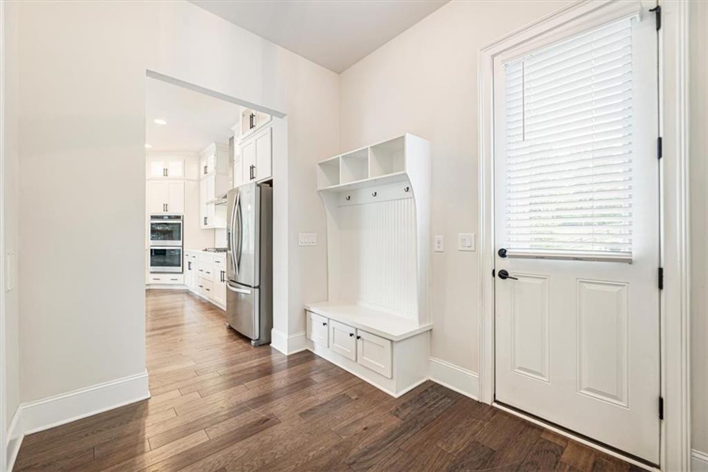 947 Hunter Way Milton, GA 30004 - Photo 42 of 78 a view of a kitchen with wooden floor and a refrigerator