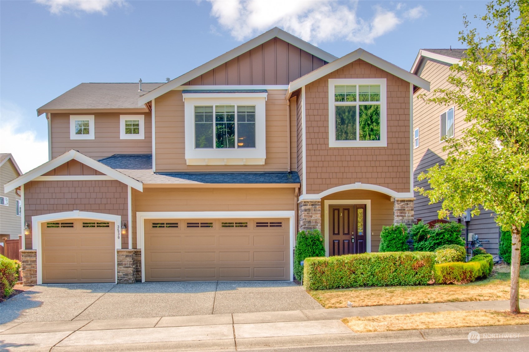 3530 215th Place Southeast Bothell, WA 98021 - Photo 1 of 35 a front view of a house with a yard and garage