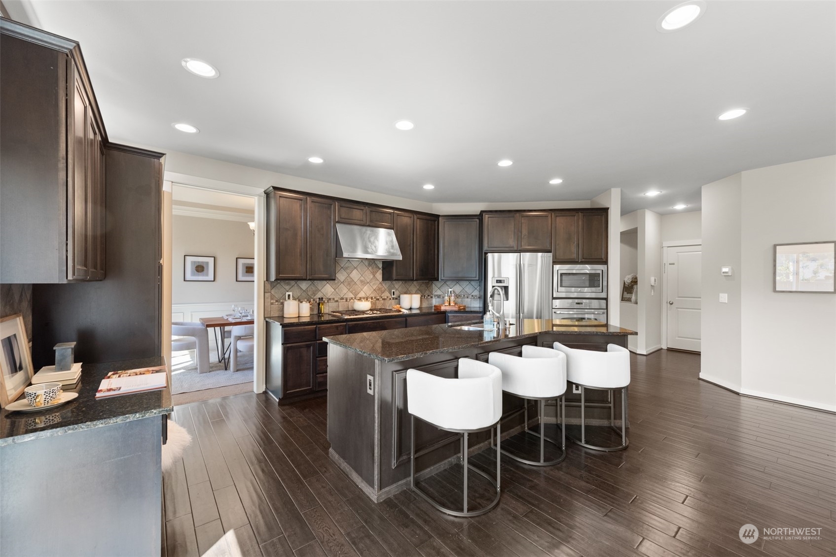 3530 215th Place Southeast Bothell, WA 98021 - Photo 11 of 35 a kitchen with a dining table chairs wooden floor appliances and a counter top space