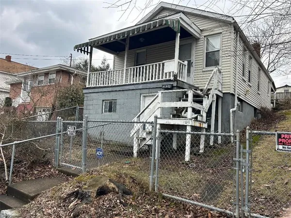 a view of a house with a wooden deck