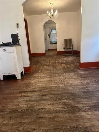 a living room with furniture and a mirror