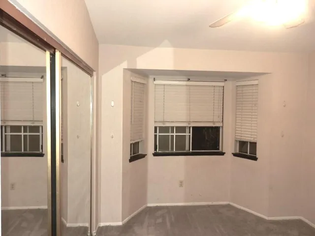 a bedroom with a bed and a ceiling fan