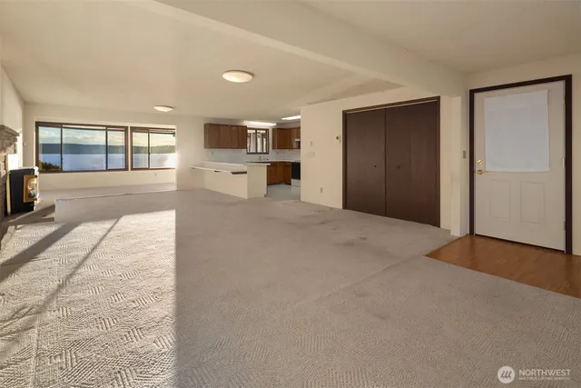 a large white kitchen with stainless steel appliances granite countertop a sink and cabinets