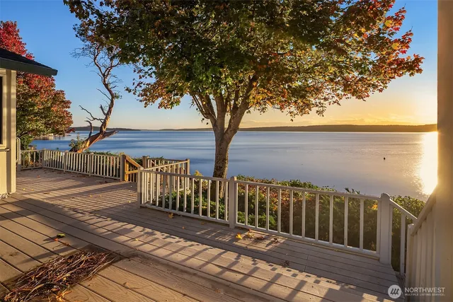a view of deck with wooden floor and fence with a trees