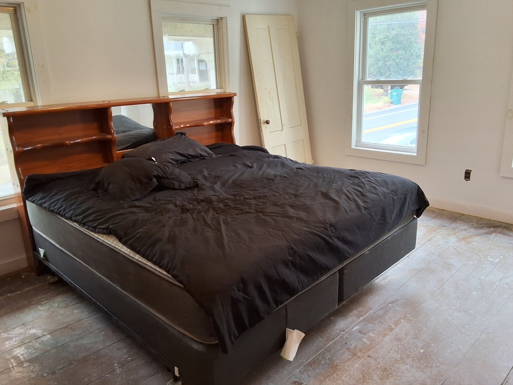 72 Maple Street Warren, MA 01083 - Photo 12 of 16 a bed sitting in a bedroom next to a window