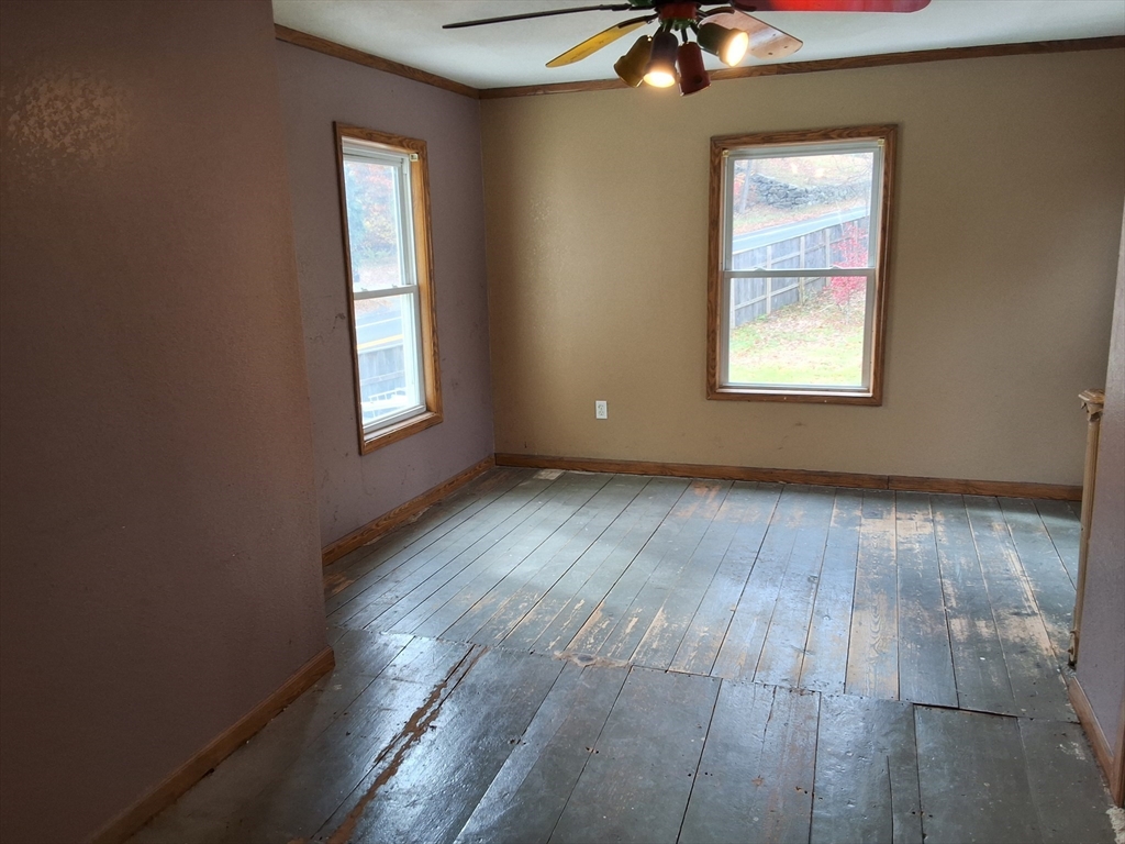72 Maple Street Warren, MA 01083 - Photo 15 of 16 an empty room with wooden floor windows and fan