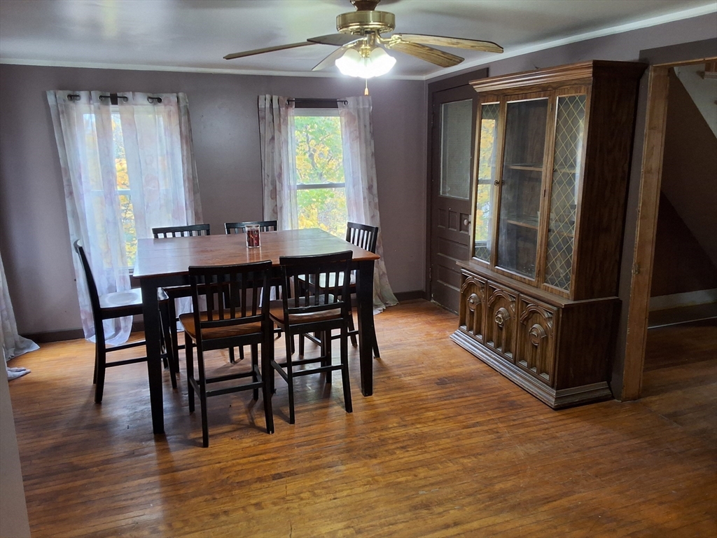 72 Maple Street Warren, MA 01083 - Photo 5 of 16 a dining room with furniture a chandelier and wooden floor
