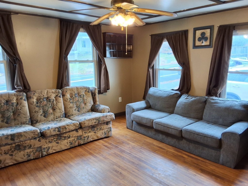 72 Maple Street Warren, MA 01083 - Photo 10 of 16 a living room with furniture and a large window