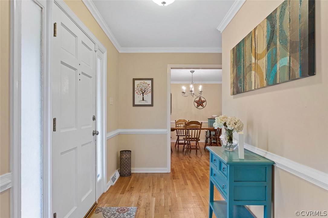 4409 Fordham Road Chesterfield, VA 23236 - Photo 3 of 27 a view of a hallway with wooden floor and dining room