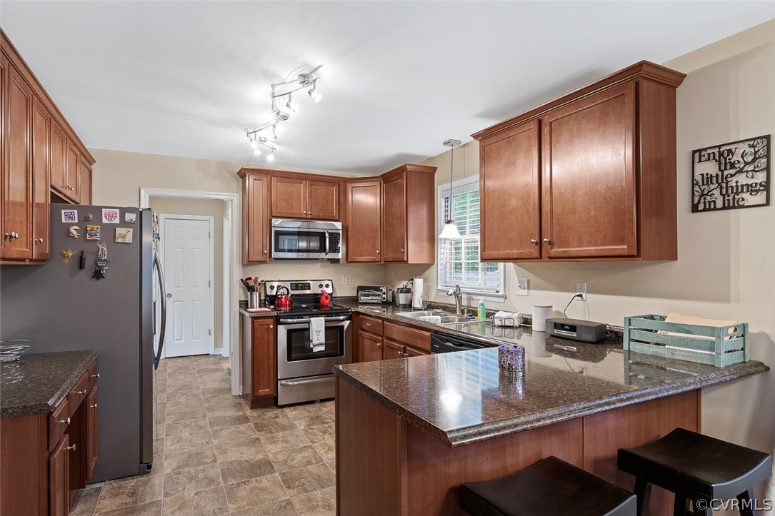 4409 Fordham Road Chesterfield, VA 23236 - Photo 7 of 27 a kitchen with stainless steel appliances granite countertop a sink stove and refrigerator