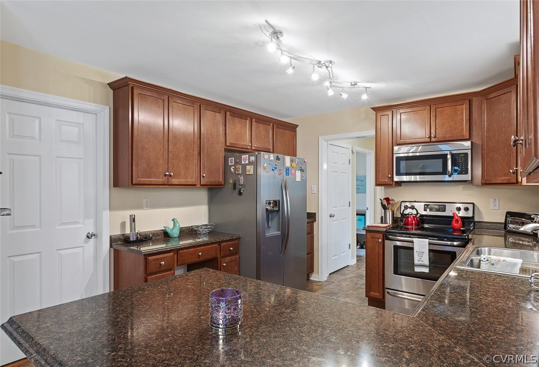 4409 Fordham Road Chesterfield, VA 23236 - Photo 8 of 27 a kitchen with stainless steel appliances granite countertop a refrigerator stove top oven and sink