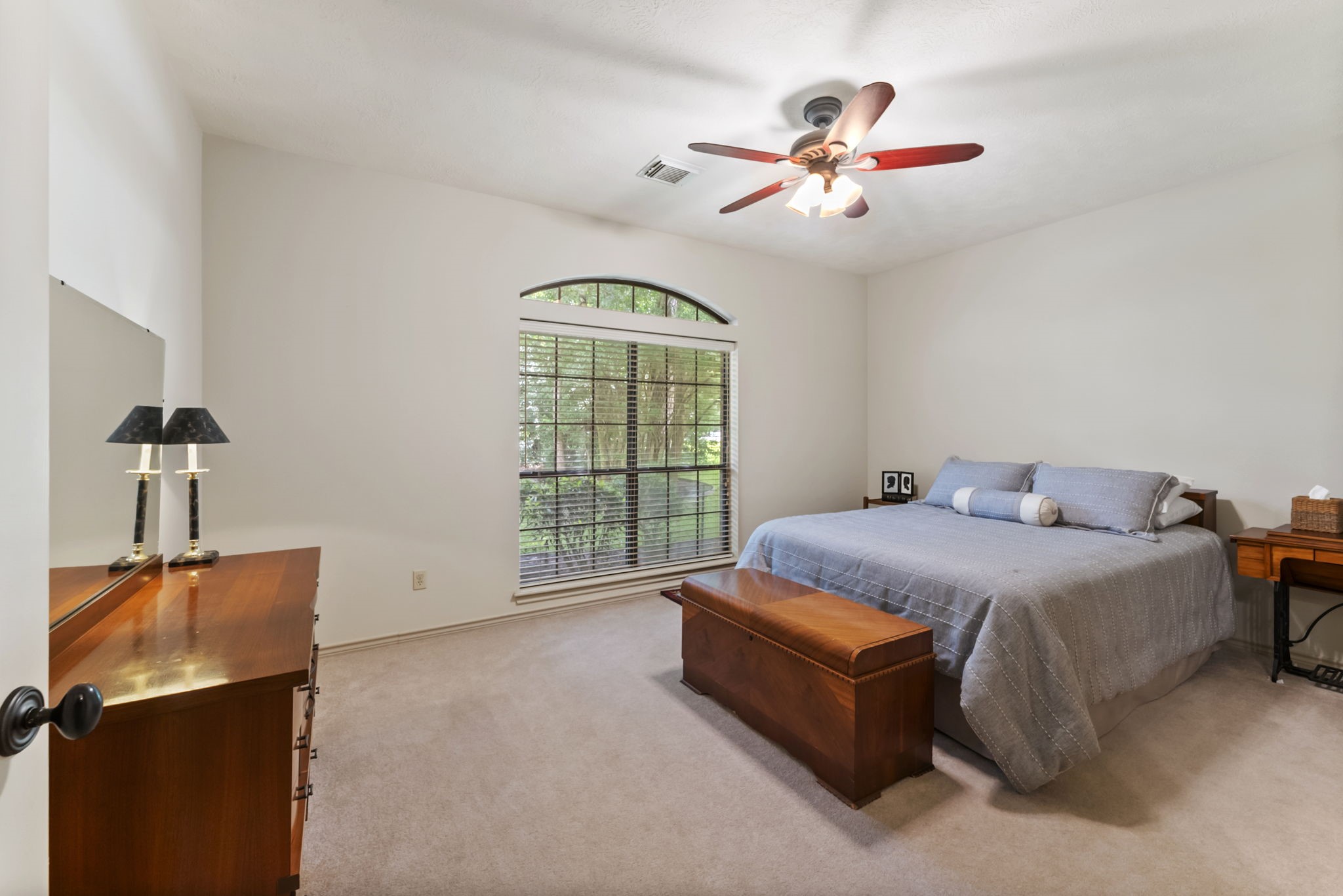 24311 Standing Oak Drive Spring, TX 77389 - Photo 32 of 42 a spacious bedroom with a bed and a chandelier