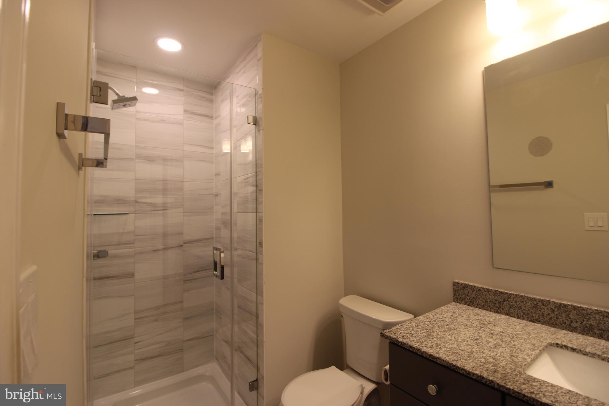 3007 Mission Square Drive Fairfax, VA 22031 - Photo 13 of 13 a bathroom with a granite countertop sink toilet and shower