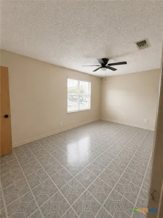 a view of an empty room with windows