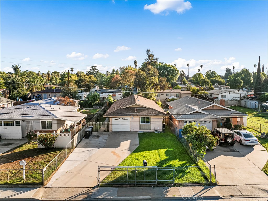 a aerial view of a house with a garden and trees