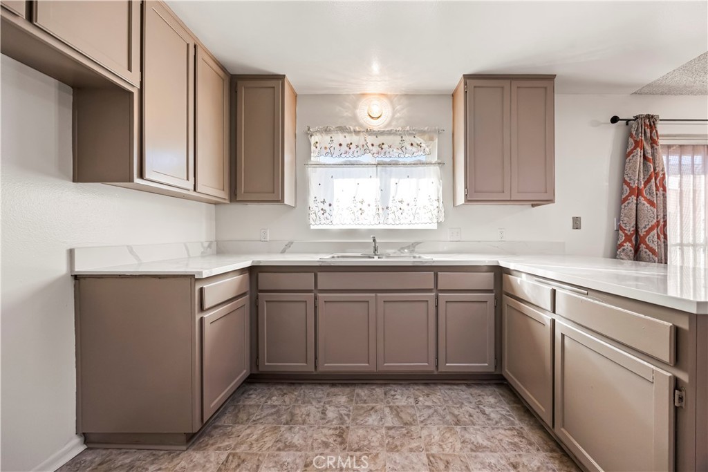 2520 14th Street Riverside, CA 92507 - Photo 6 of 17 a kitchen with a sink stove and cabinets