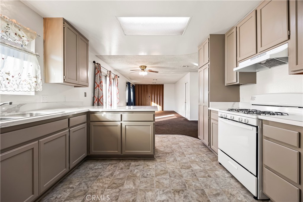 2520 14th Street Riverside, CA 92507 - Photo 7 of 17 a kitchen with granite countertop a sink stove and cabinets
