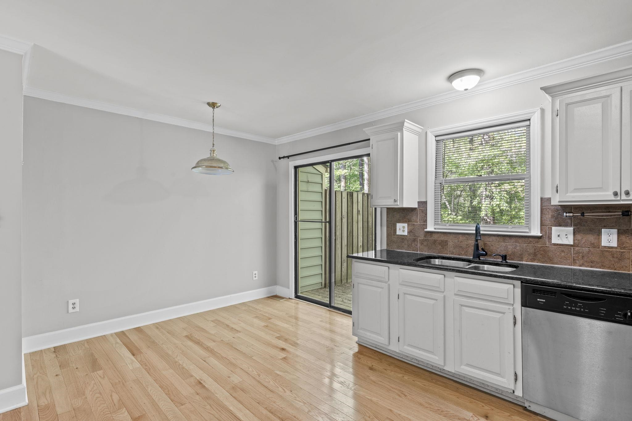 6506 Thetford Court Raleigh, NC 27615 - Photo 13 of 26 a kitchen with a sink cabinets and window