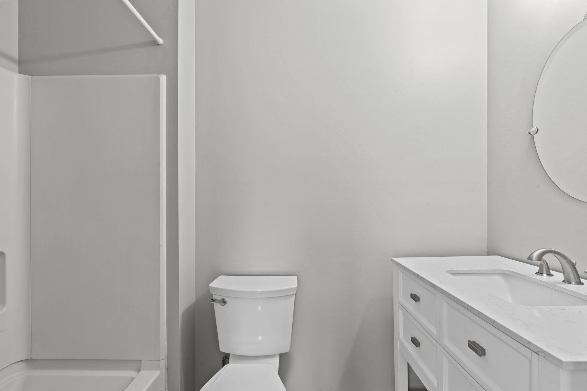 6506 Thetford Court Raleigh, NC 27615 - Photo 19 of 26 a bathroom with a toilet sink and mirror