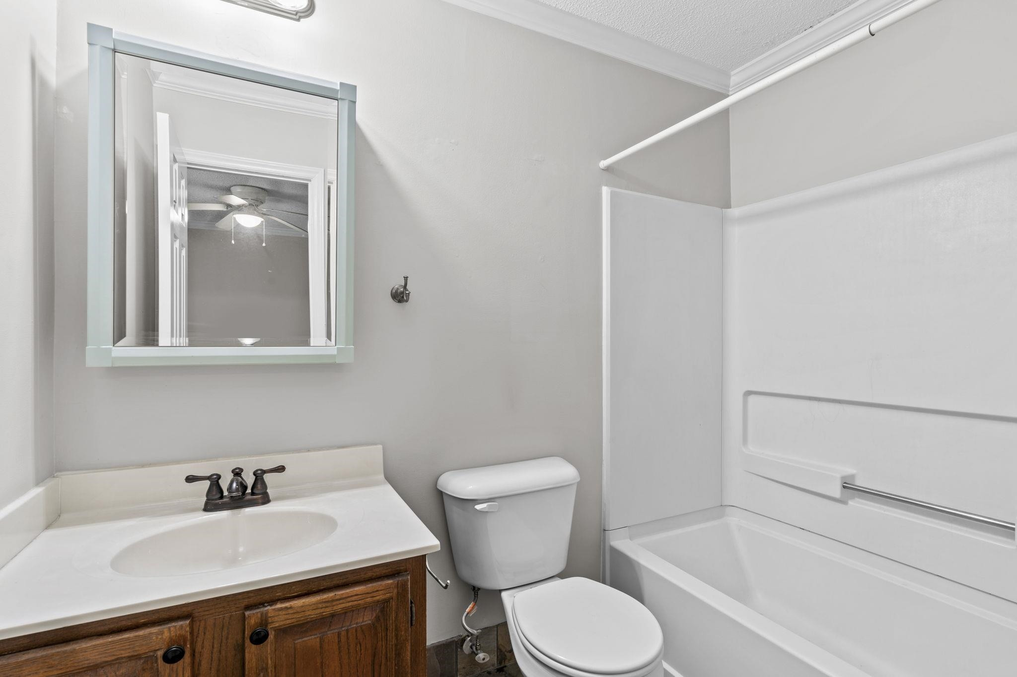 6506 Thetford Court Raleigh, NC 27615 - Photo 22 of 26 a bathroom with a sink mirror toilet and vanity