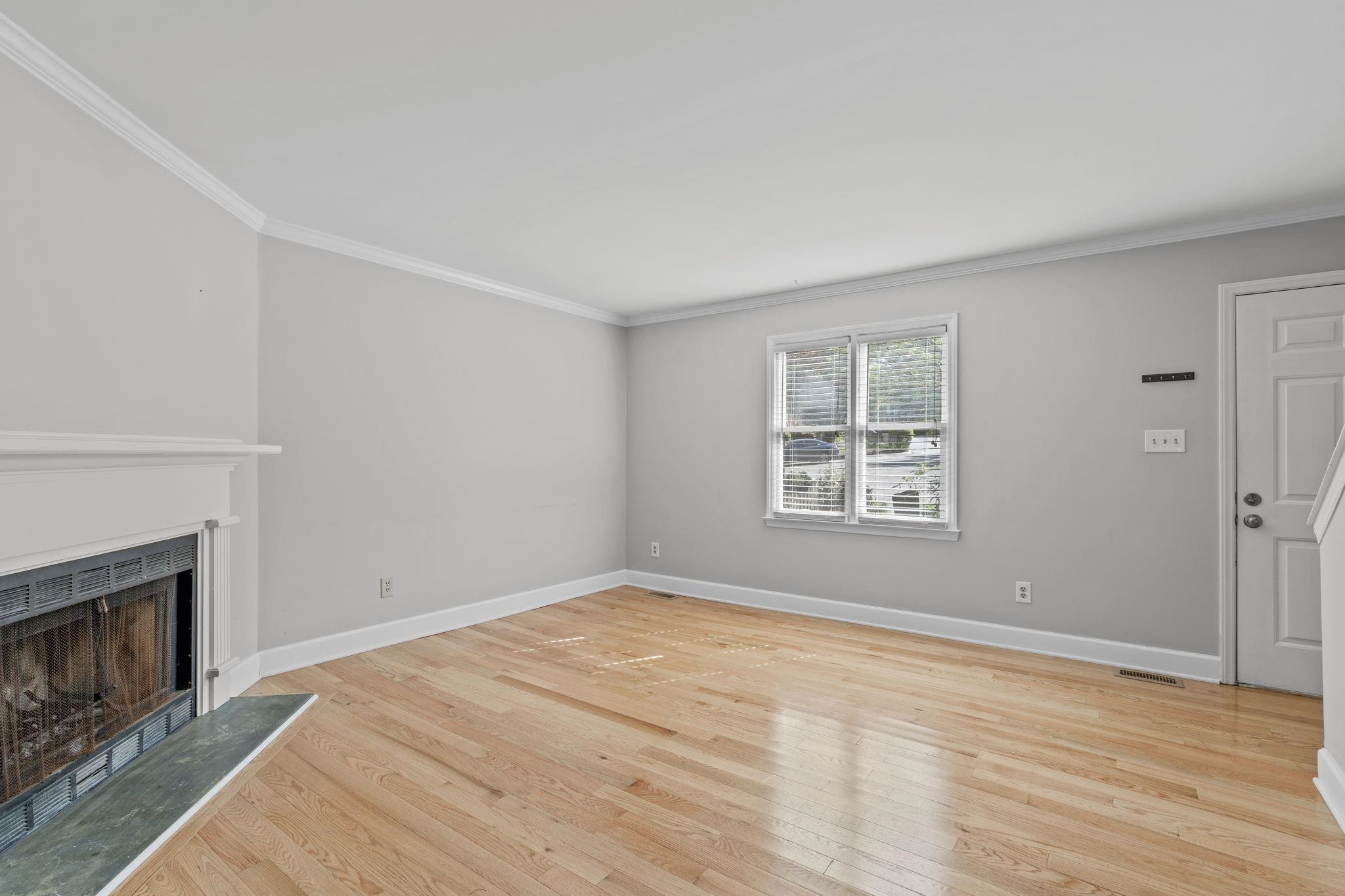 6506 Thetford Court Raleigh, NC 27615 - Photo 6 of 26 a view of empty room with wooden floor and fireplace