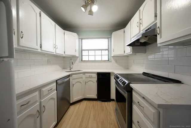a kitchen with a sink stove and cabinets