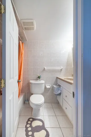 a bathroom with a toilet a sink and a window