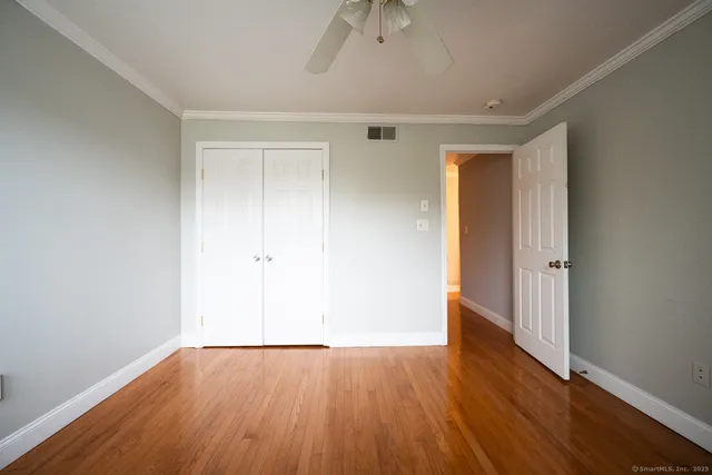 an empty room with wooden floor