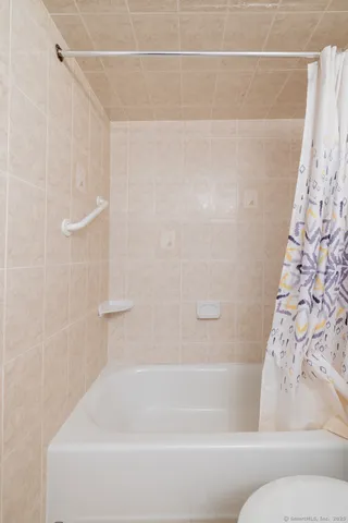a bathroom with a bathtub and shower