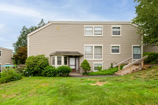 a front view of house with yard and green space