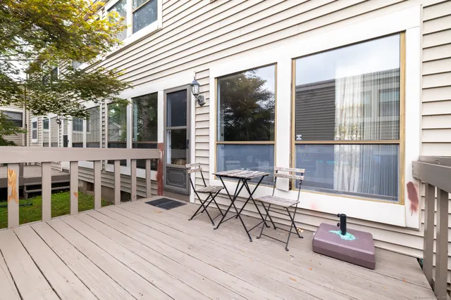 a balcony with furniture and wooden floor