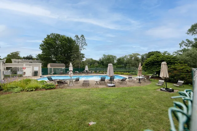 a view of a backyard with sitting area