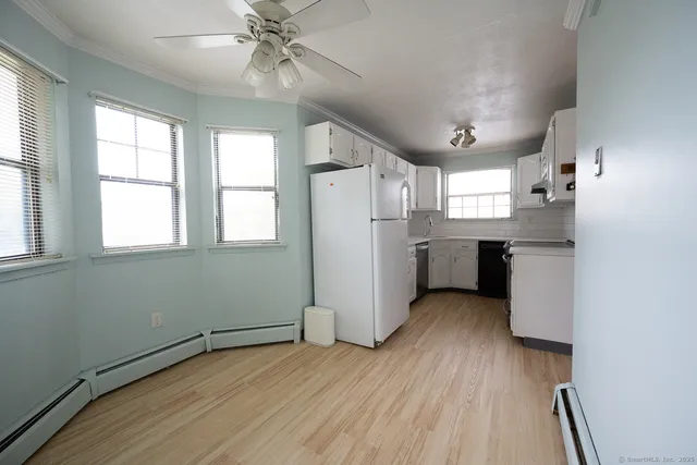 a view of a kitchen with a stove cabinets and wooden floor