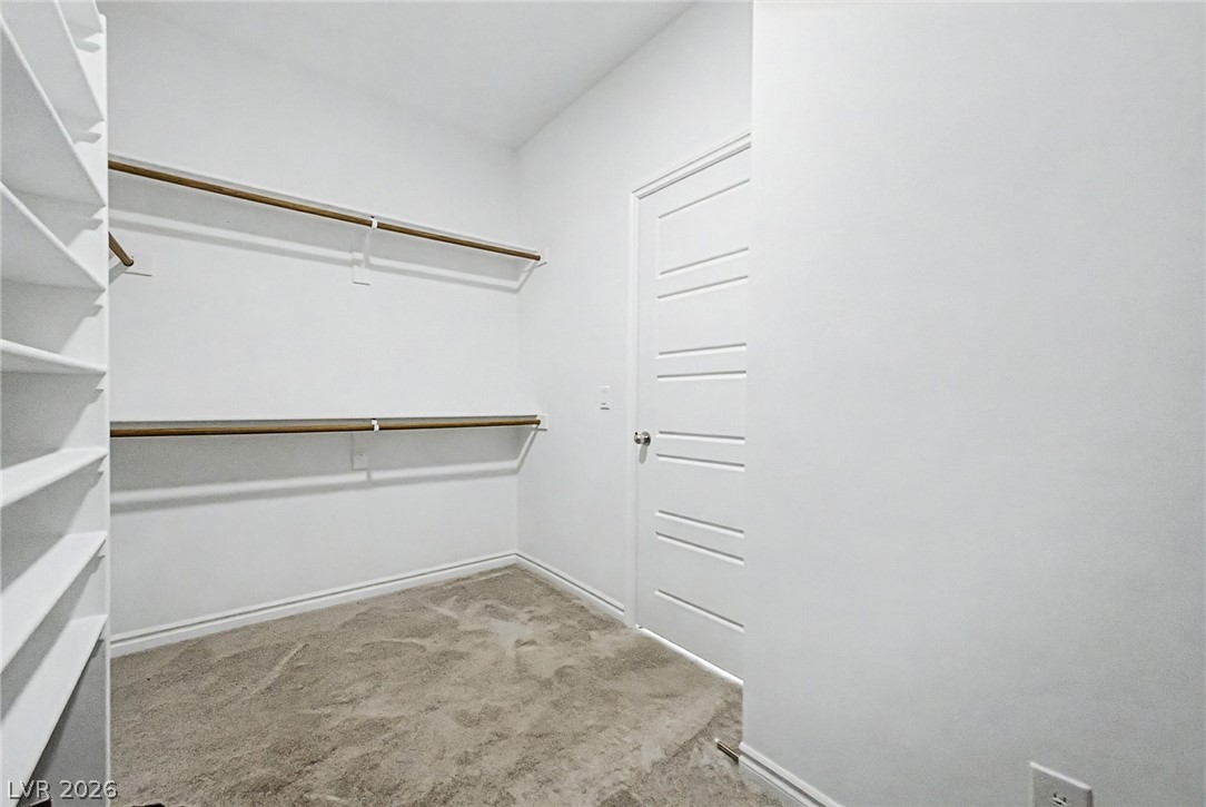 226 Augusta Ridge Henderson, NV 89015 - Photo 14 of 47 This ample walk-in closet features convenient shelving and hanging rods for optimal organization.