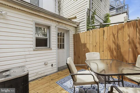 a balcony with table and chairs