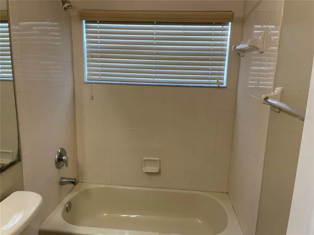 a bathroom with a tub and a sink