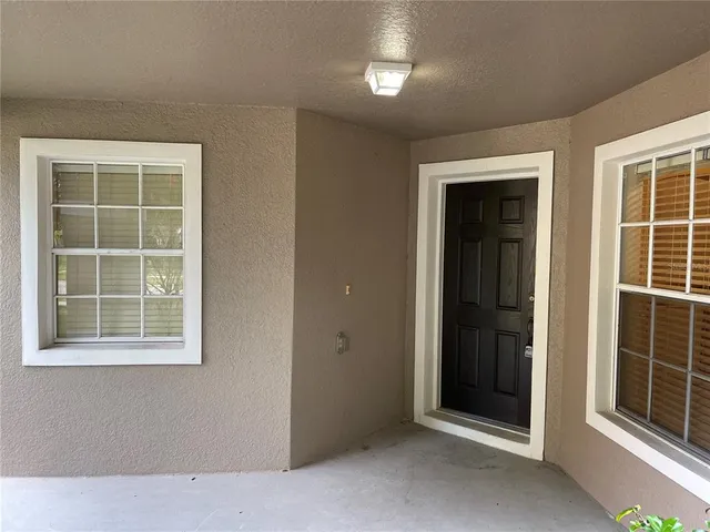 a view of an empty room with windows