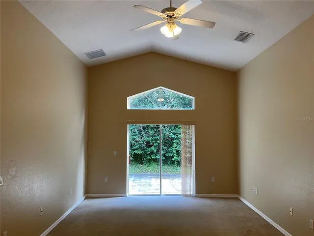 a view of a livingroom with a ceiling fan and window