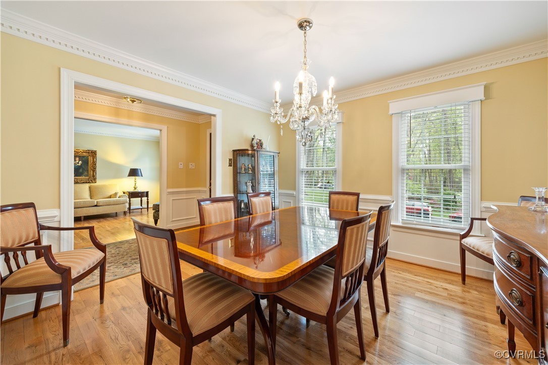 14204 Chimney House Road Midlothian, VA 23112 - Photo 13 of 39 a dining room with furniture a chandelier and wooden floor