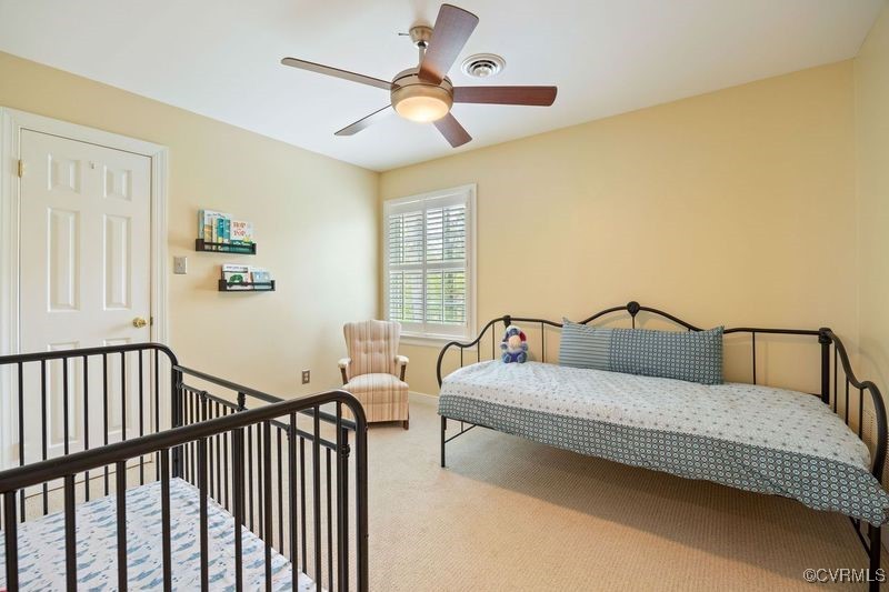14204 Chimney House Road Midlothian, VA 23112 - Photo 29 of 39 a bedroom with a bed and a chandelier